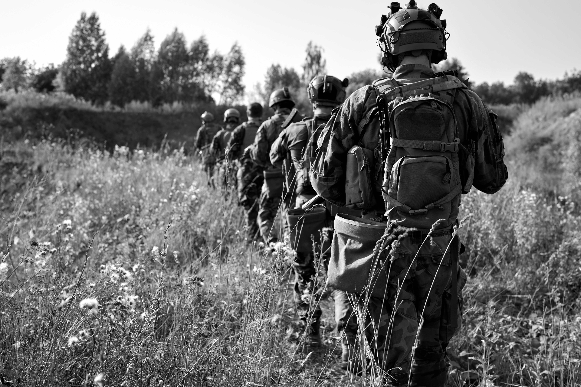 Soldiers in tactical gear deployed in the field
