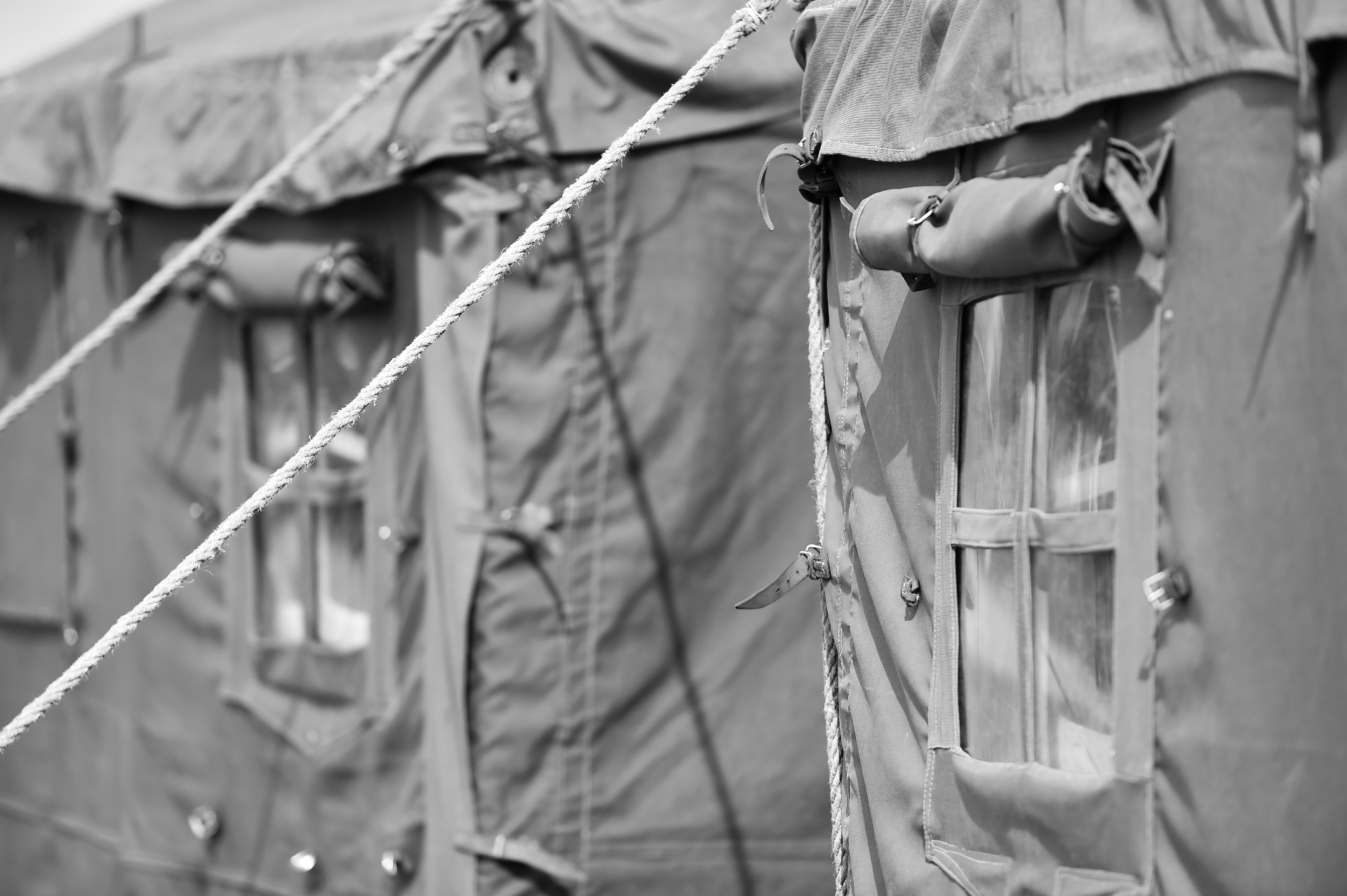 Close-up of canvas tactical shelter with rope and buckles